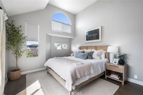 a bedroom with a bed and a potted plant
