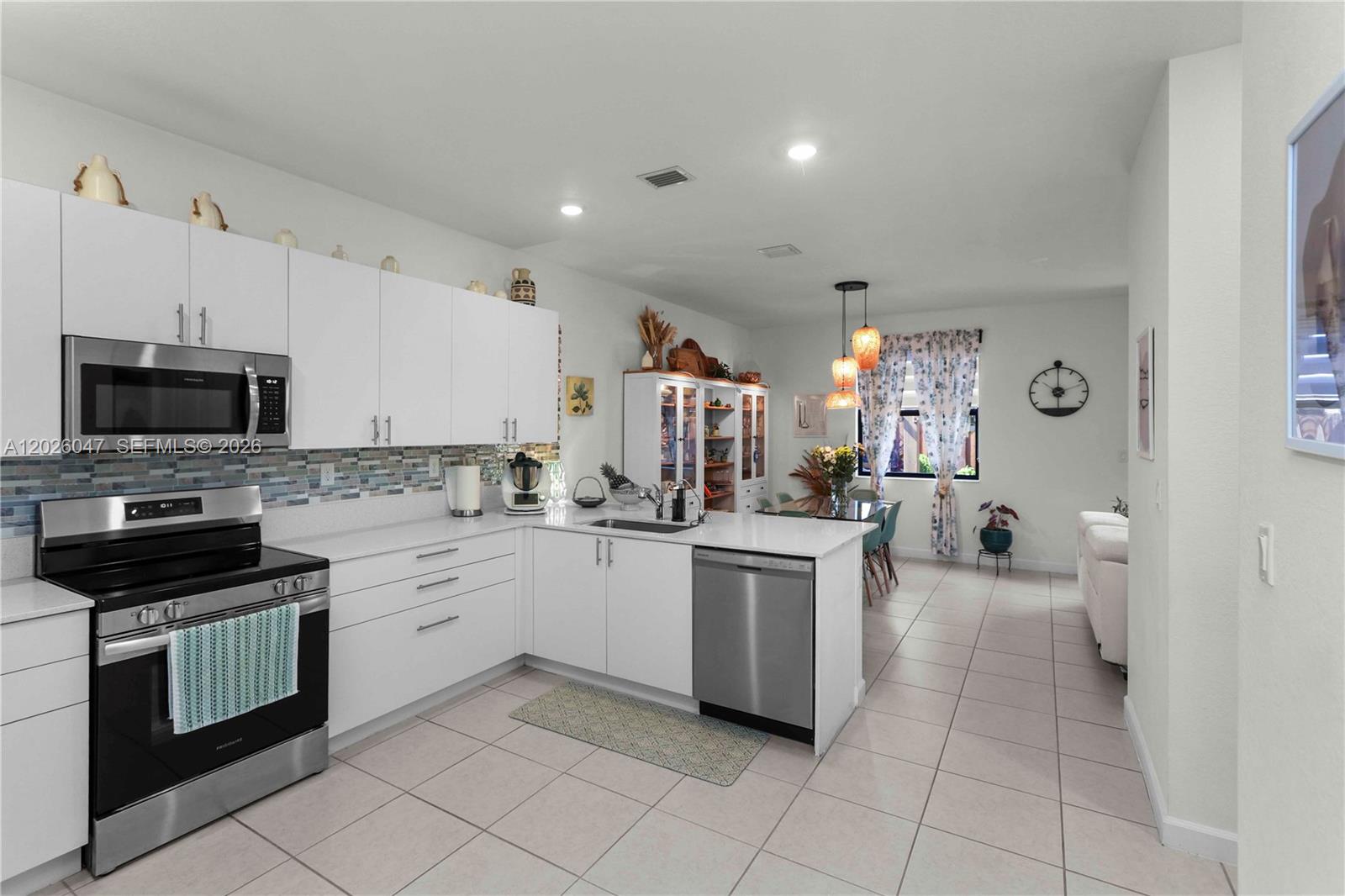 12862 Southwest 231st Street Miami, FL 33170 - Photo 8 of 30 a kitchen with a sink and white cabinets