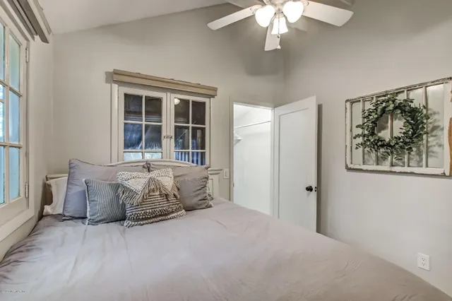 a bed sitting in a bedroom next to a window