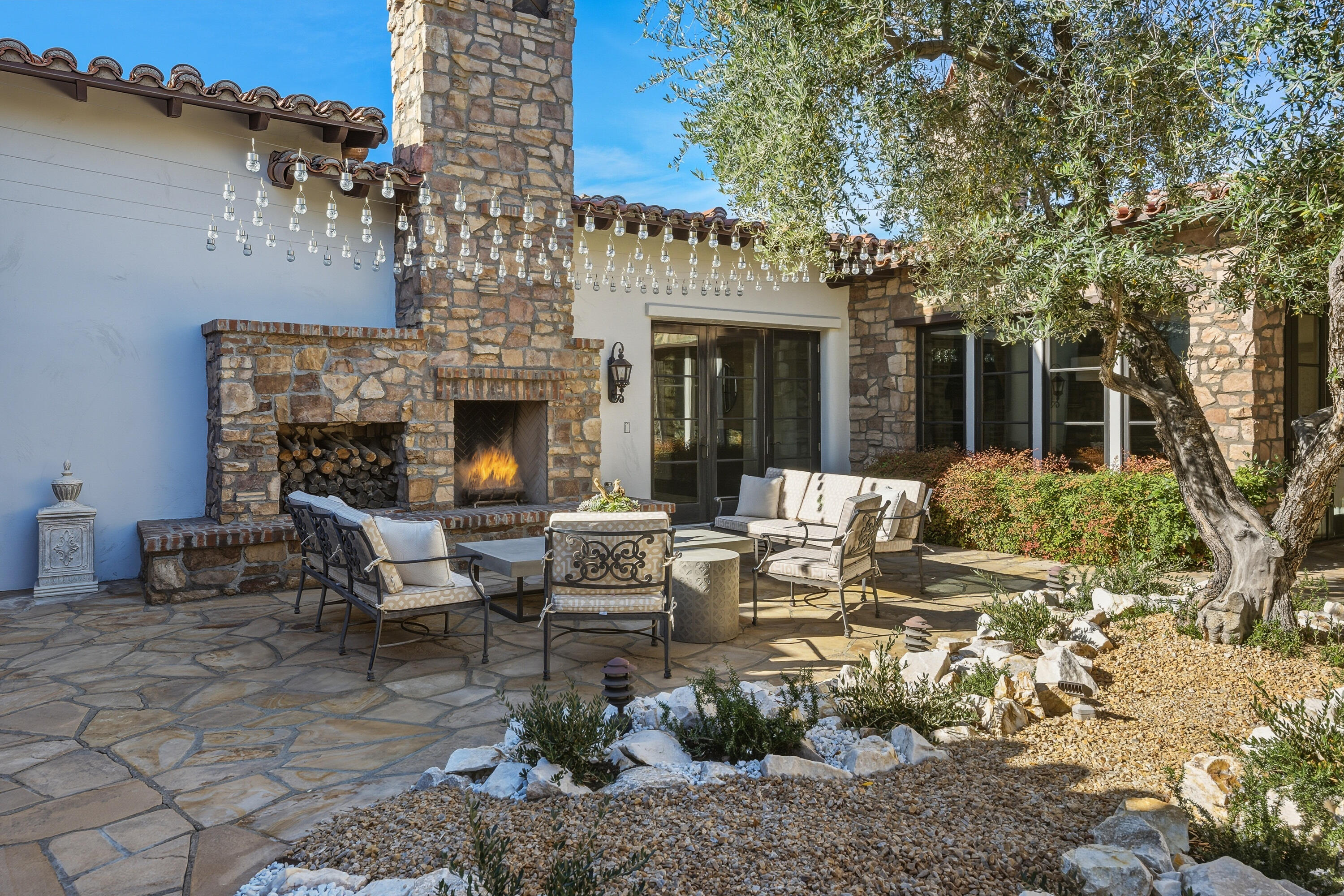 4 Via L' Antico Rancho Mirage, CA 92270 - Photo 15 of 75 a view of a patio with couches table and chairs and potted plants