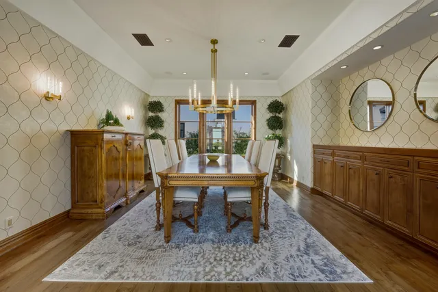 a bathroom with a granite countertop toilet a sink and a mirror