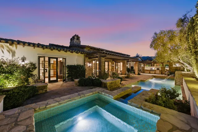 a view of a house with backyard sitting area and tub