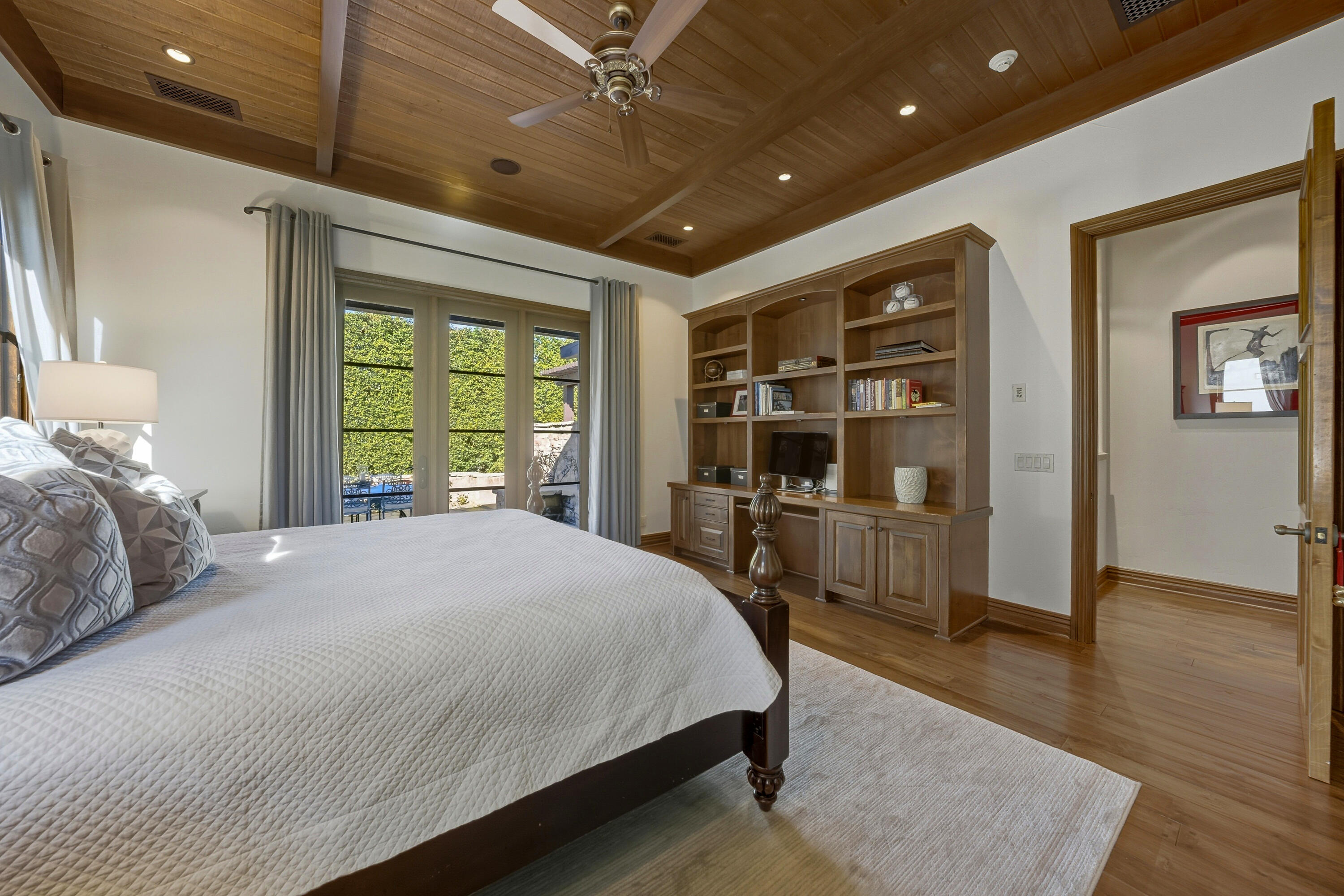 4 Via L' Antico Rancho Mirage, CA 92270 - Photo 35 of 75 a spacious bedroom with a large bed and a wooden floor