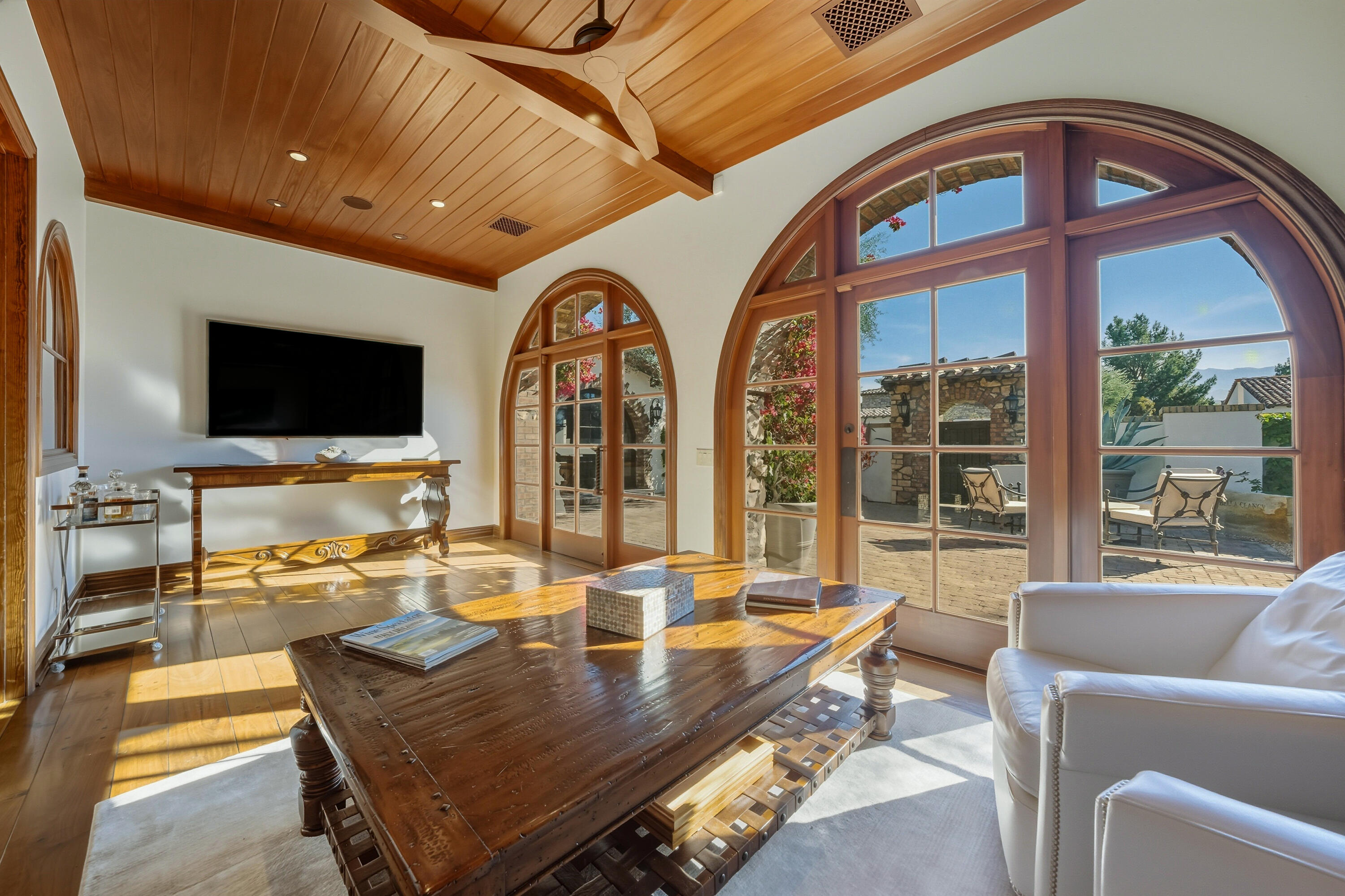 4 Via L' Antico Rancho Mirage, CA 92270 - Photo 38 of 75 a living room with furniture a flat screen tv and a large window