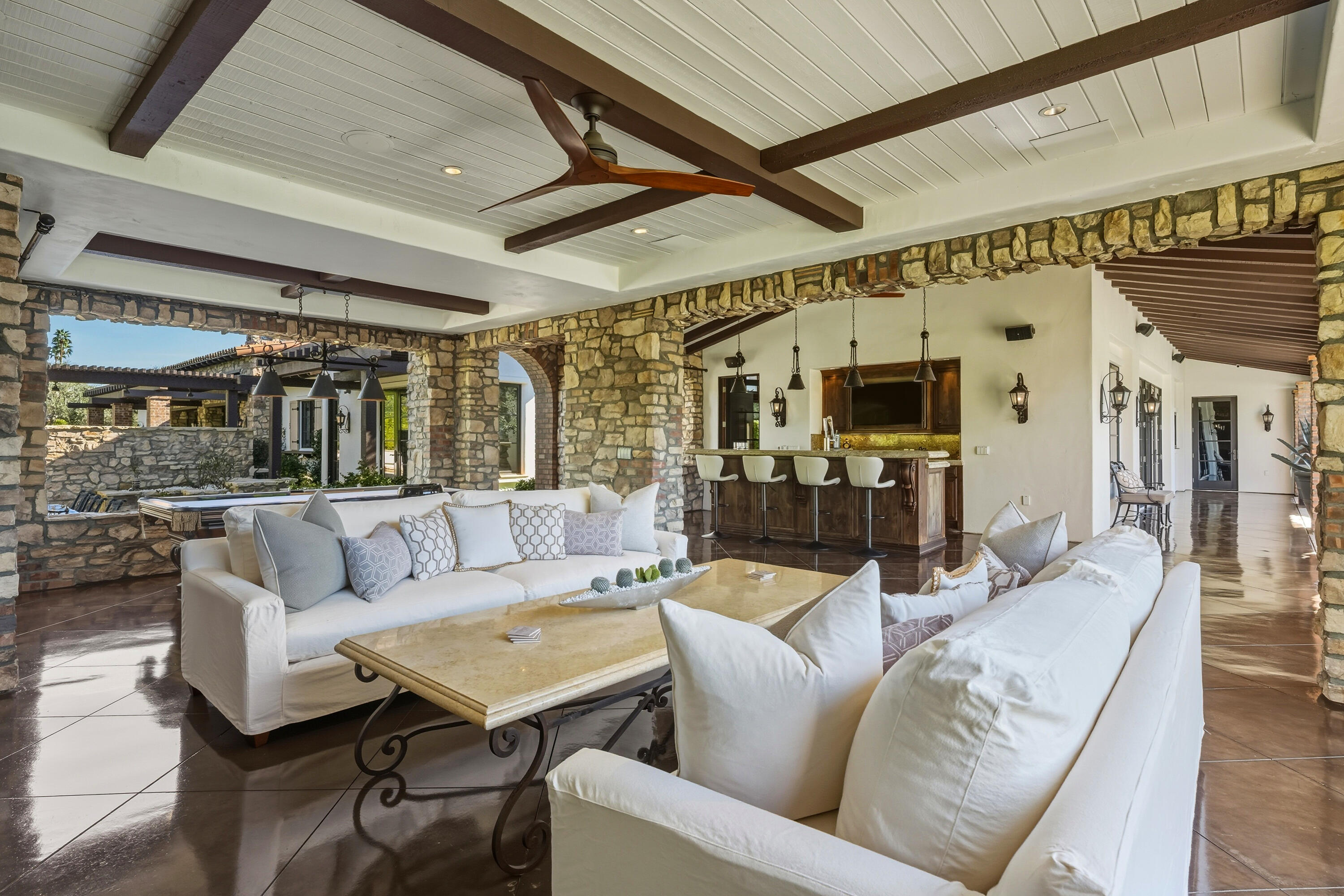 4 Via L' Antico Rancho Mirage, CA 92270 - Photo 48 of 75 a living room with furniture and a ceiling fan