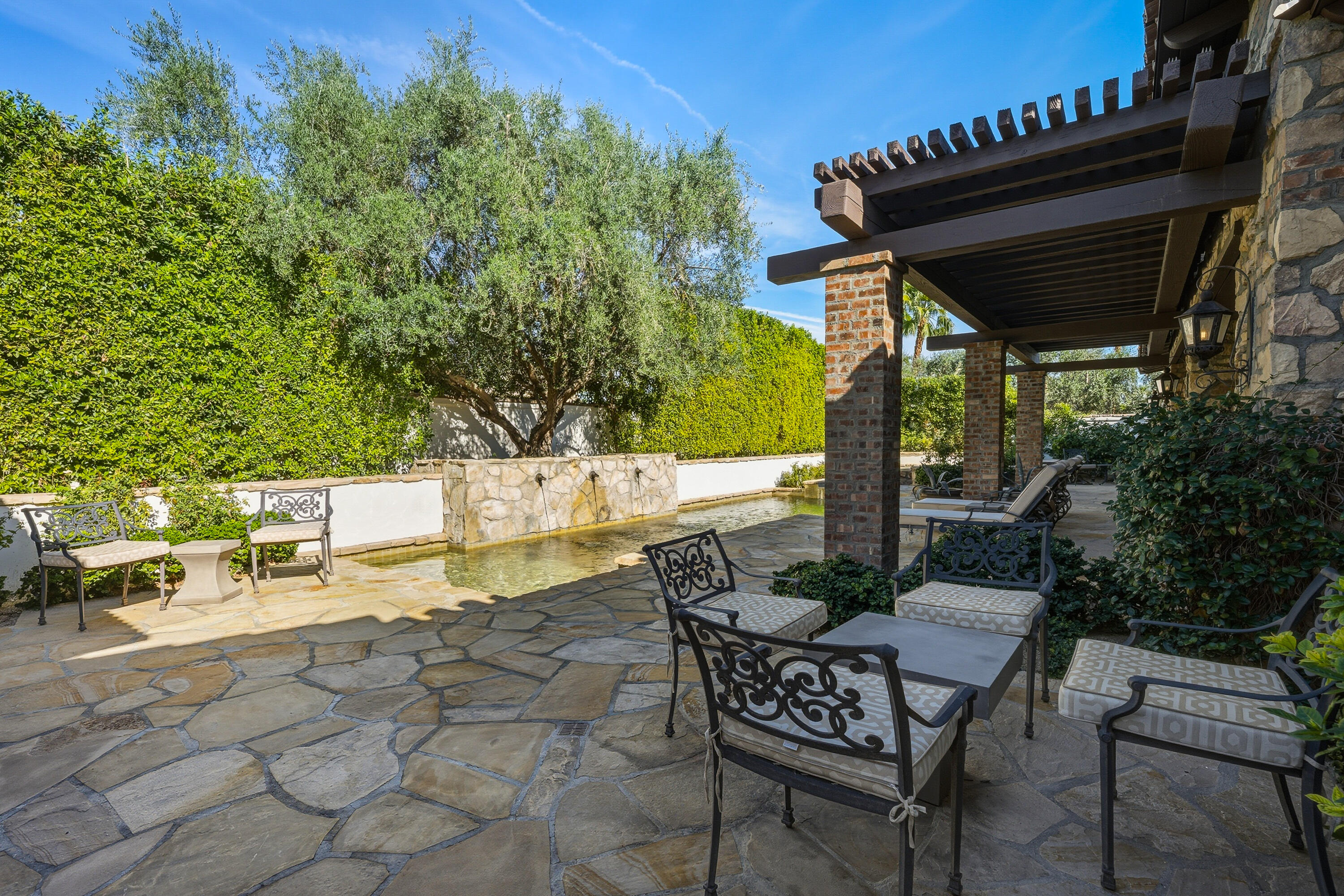 4 Via L' Antico Rancho Mirage, CA 92270 - Photo 66 of 75 a view of an outdoor sitting area with fire pit