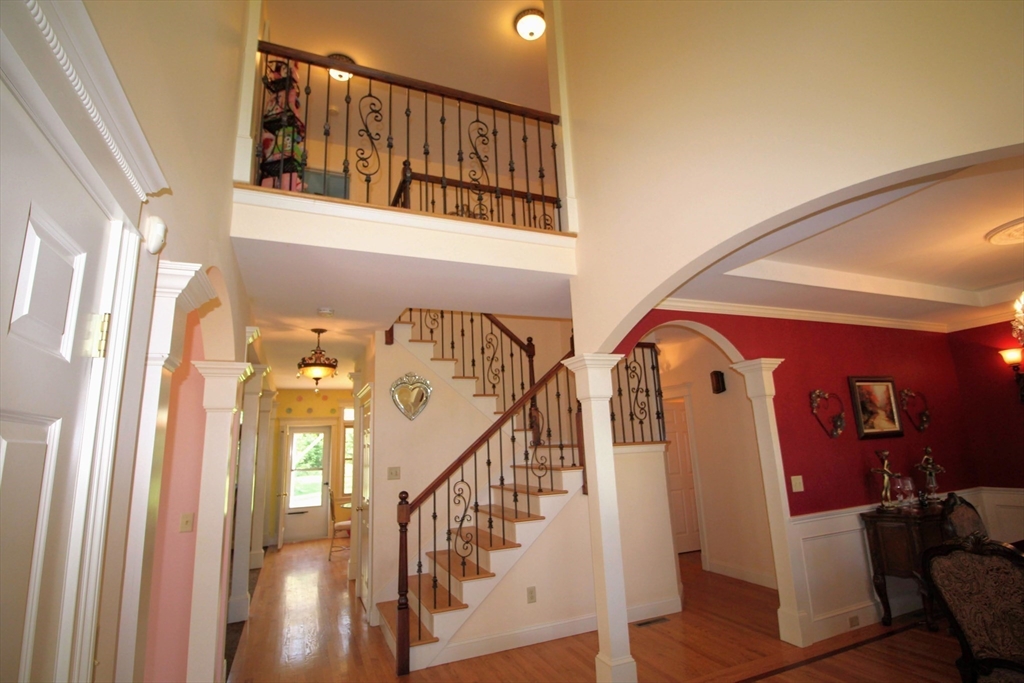 5 Gableview Lane Southwick, MA 01077 - Photo 22 of 41 a view of staircase with lots of frames on wall and a window