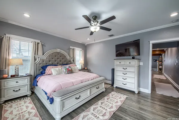 a bedroom with a large bed and a chandelier