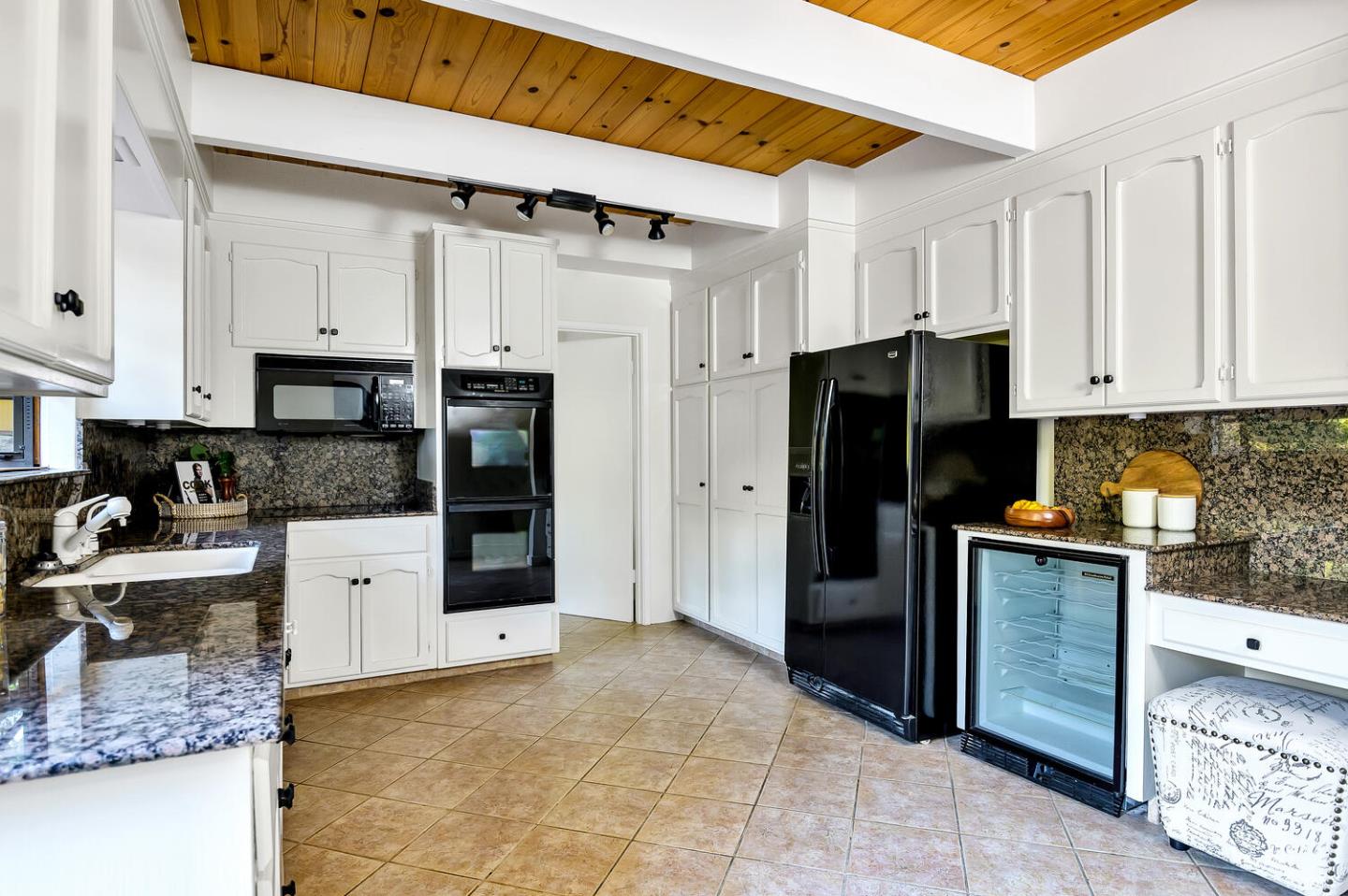 5 Morse Lane Woodside, CA 94062 - Photo 17 of 30 a kitchen with stainless steel appliances granite countertop a refrigerator oven a stove and white cabinets