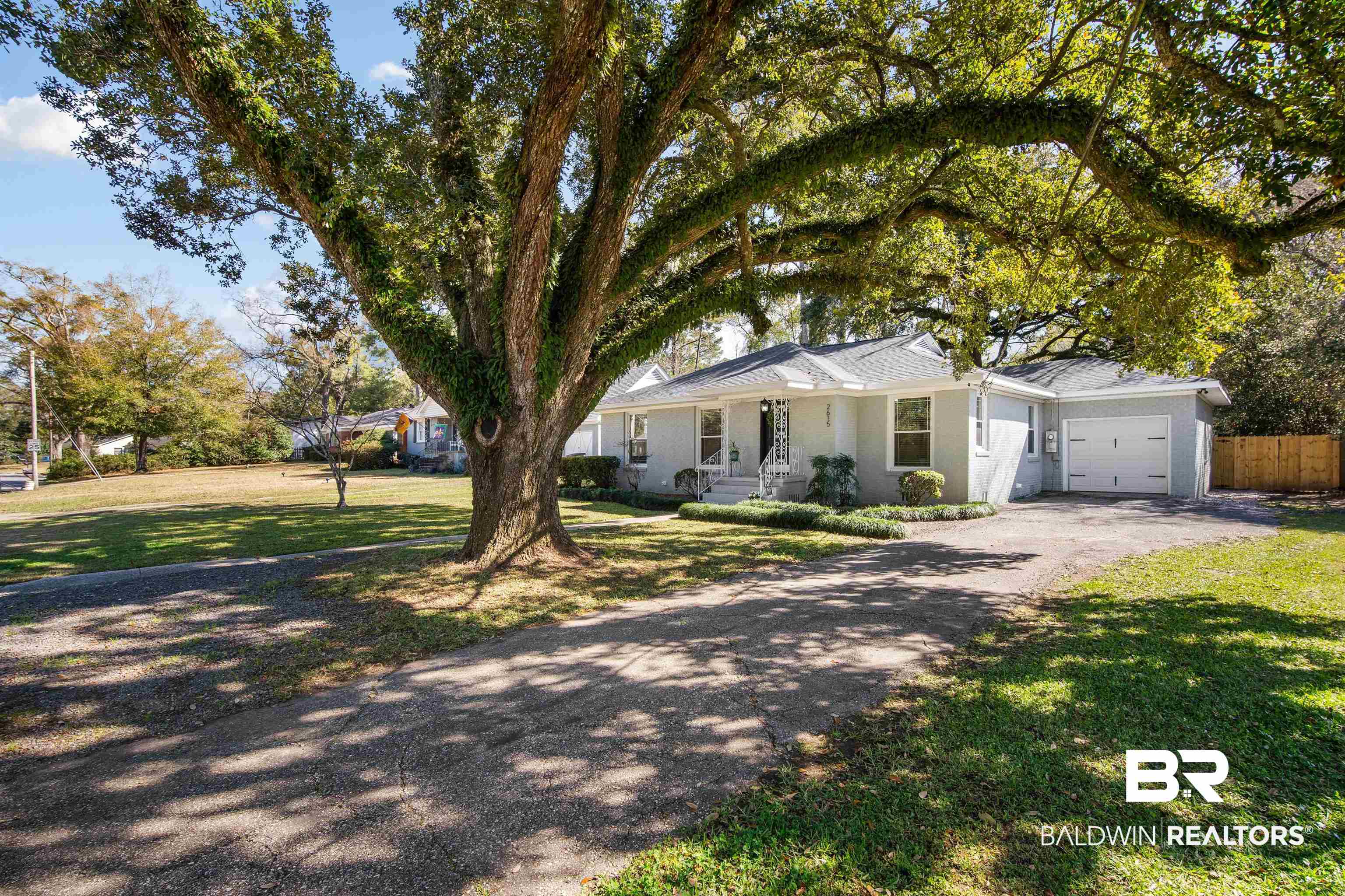 2615 Walton Avenue Mobile, AL 36606 - Photo 4 of 33 Ranch-style house featuring a garage, driveway, a front lawn, and fence