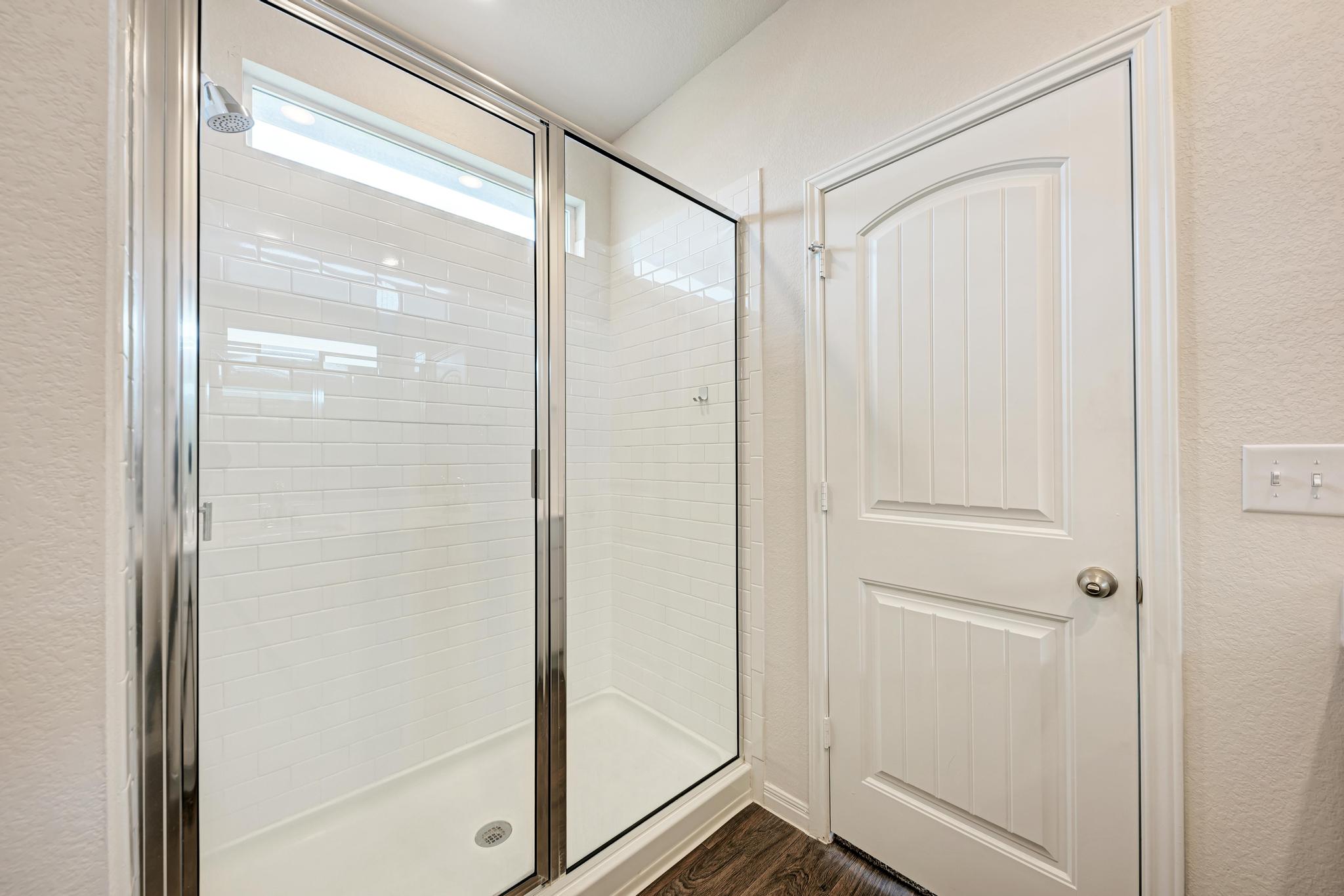 208 Abby Road Georgetown, TX 78626 - Photo 26 of 40 a bathroom with a glass shower door