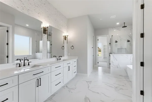 a bathroom with a double vanity sink mirror double and shower