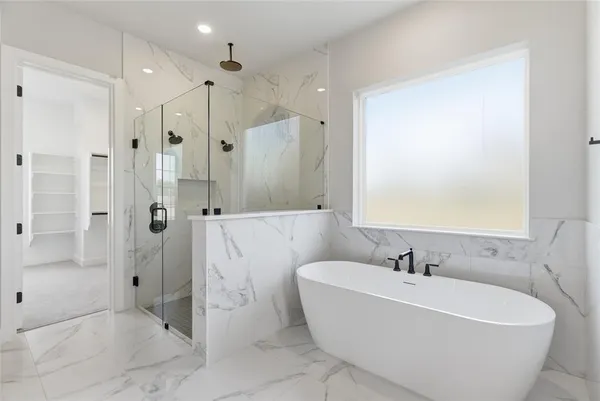 a white bath tub sitting next to a bathroom sink