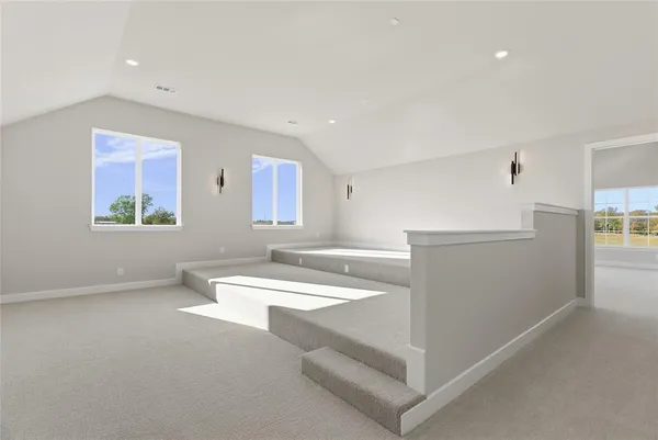 a room with a white bed and a stove