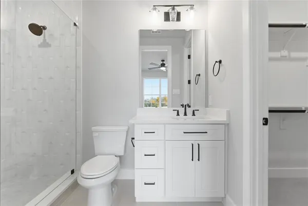 a bathroom with a sink toilet a mirror and shower