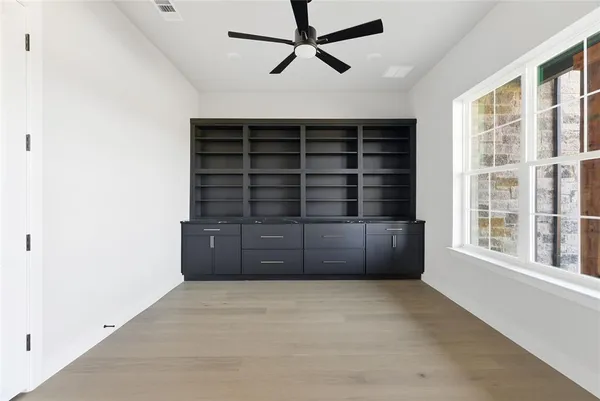 an empty room with a empty space and windows