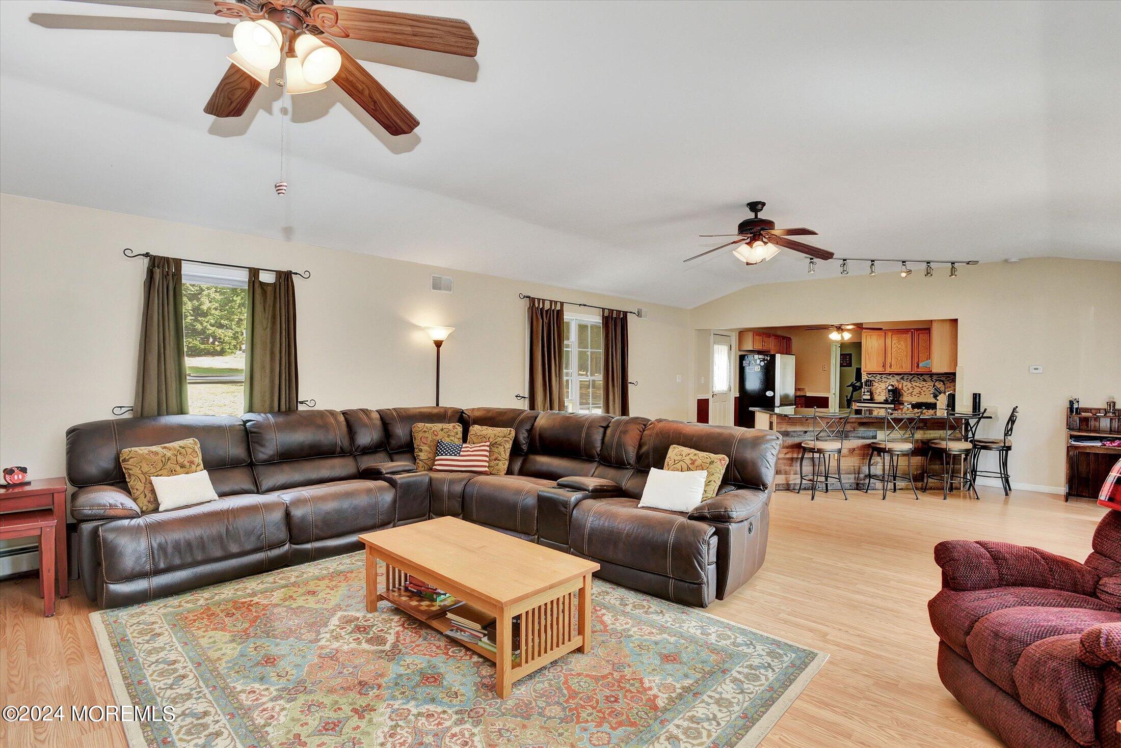 155 Tyrpak Road Howell, NJ 07731 - Photo 14 of 35 a living room with furniture ceiling fan and a rug