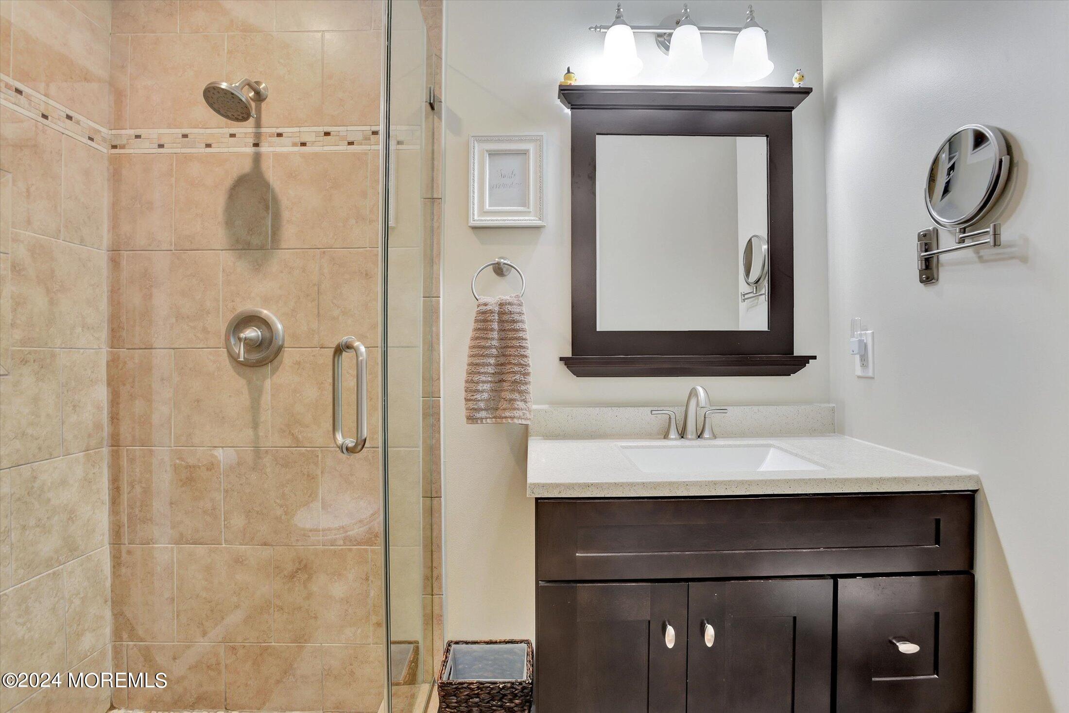 155 Tyrpak Road Howell, NJ 07731 - Photo 19 of 35 a bathroom with a sink a mirror a vanity and shower