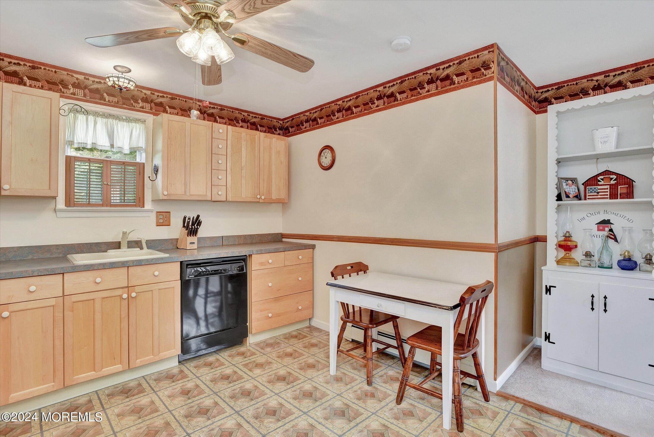 155 Tyrpak Road Howell, NJ 07731 - Photo 26 of 35 a white kitchen with a sink a stove a dining table and chairs