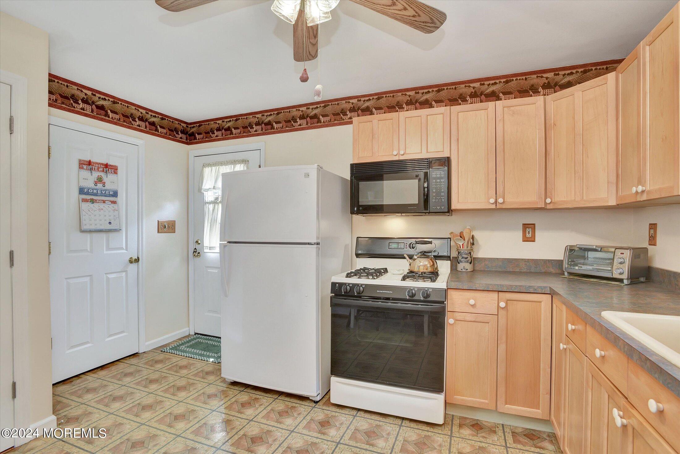 155 Tyrpak Road Howell, NJ 07731 - Photo 27 of 35 a kitchen with stainless steel appliances granite countertop a refrigerator sink and stove