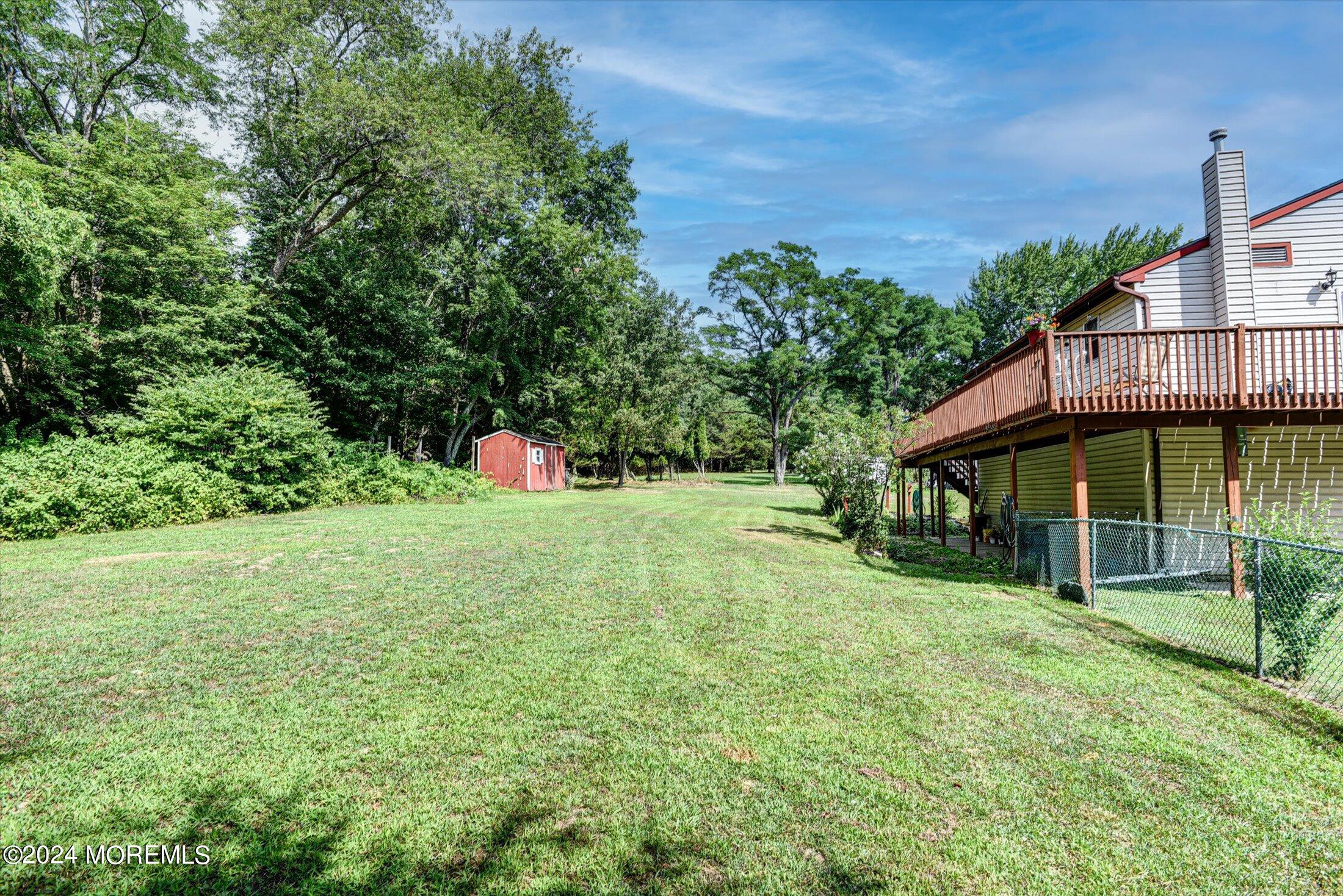 155 Tyrpak Road Howell, NJ 07731 - Photo 33 of 35 a backyard of a house with wooden floor and fence