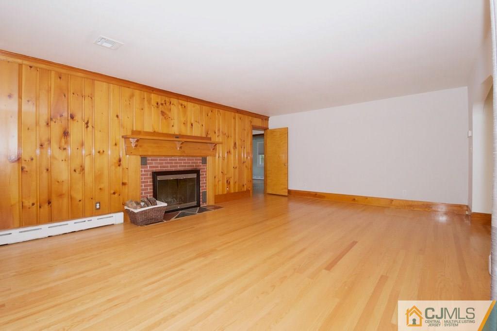 96 Smith Road Somerset, NJ 08873 - Photo 8 of 25 a view of an empty room with a fireplace and a window