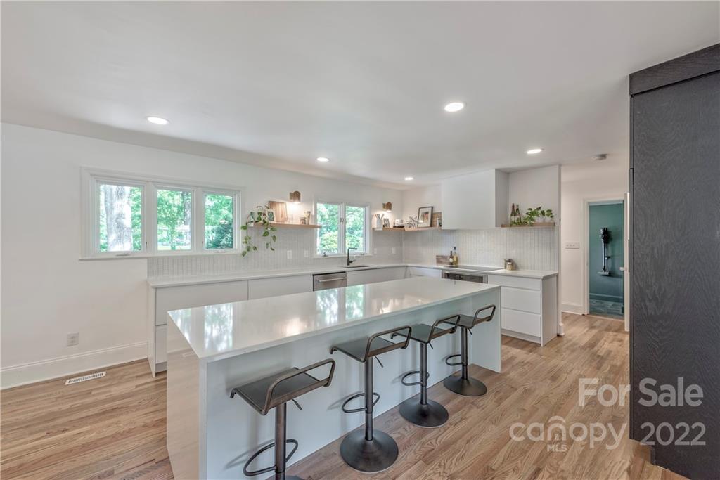 1139 Shady Bluff Drive Charlotte, NC 28211 - Photo 20 of 46 a kitchen with kitchen island a sink table and chairs