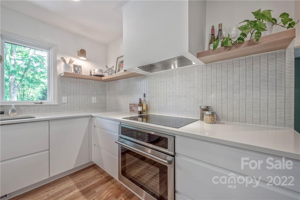 1139 Shady Bluff Drive Charlotte, NC 28211 - Photo 23 of 46 a kitchen with a sink a stove and cabinets