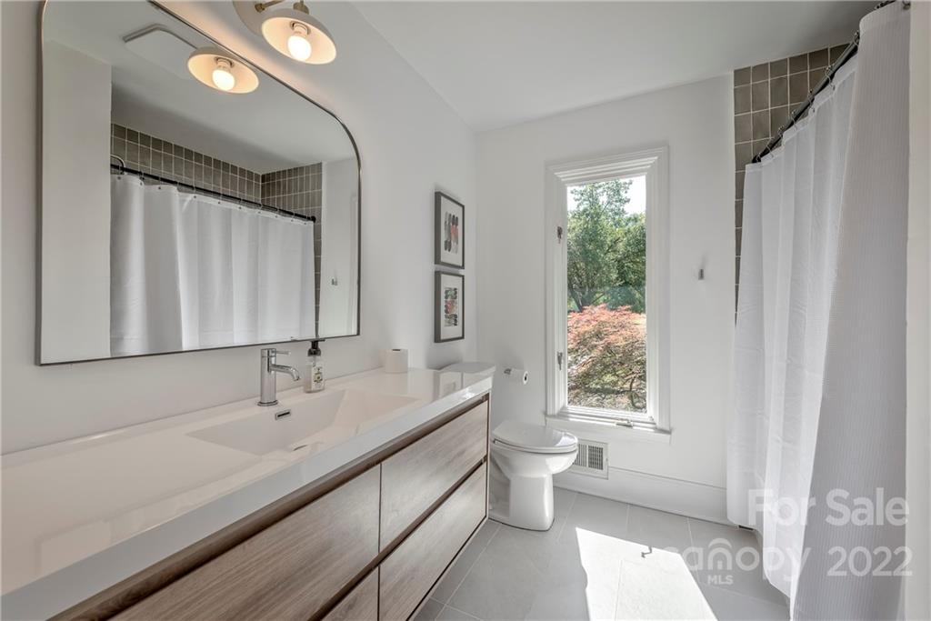 1139 Shady Bluff Drive Charlotte, NC 28211 - Photo 28 of 46 a bathroom with a double vanity sink toilet and a mirror