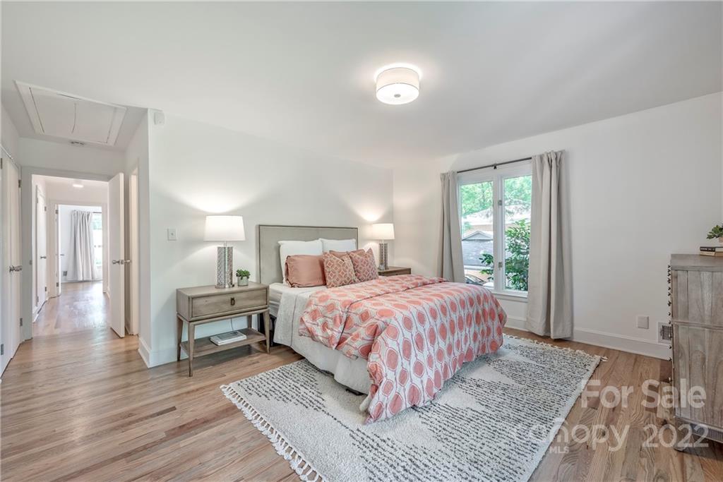 1139 Shady Bluff Drive Charlotte, NC 28211 - Photo 29 of 46 a bedroom with a large bed and a wooden floor