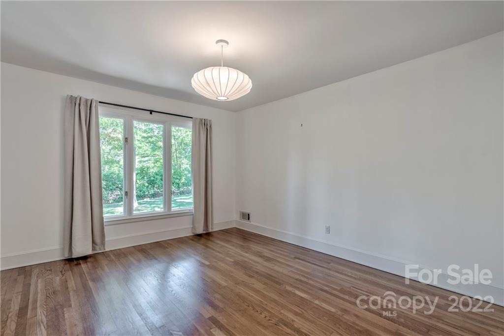 1139 Shady Bluff Drive Charlotte, NC 28211 - Photo 36 of 46 an empty room with wooden floor and windows