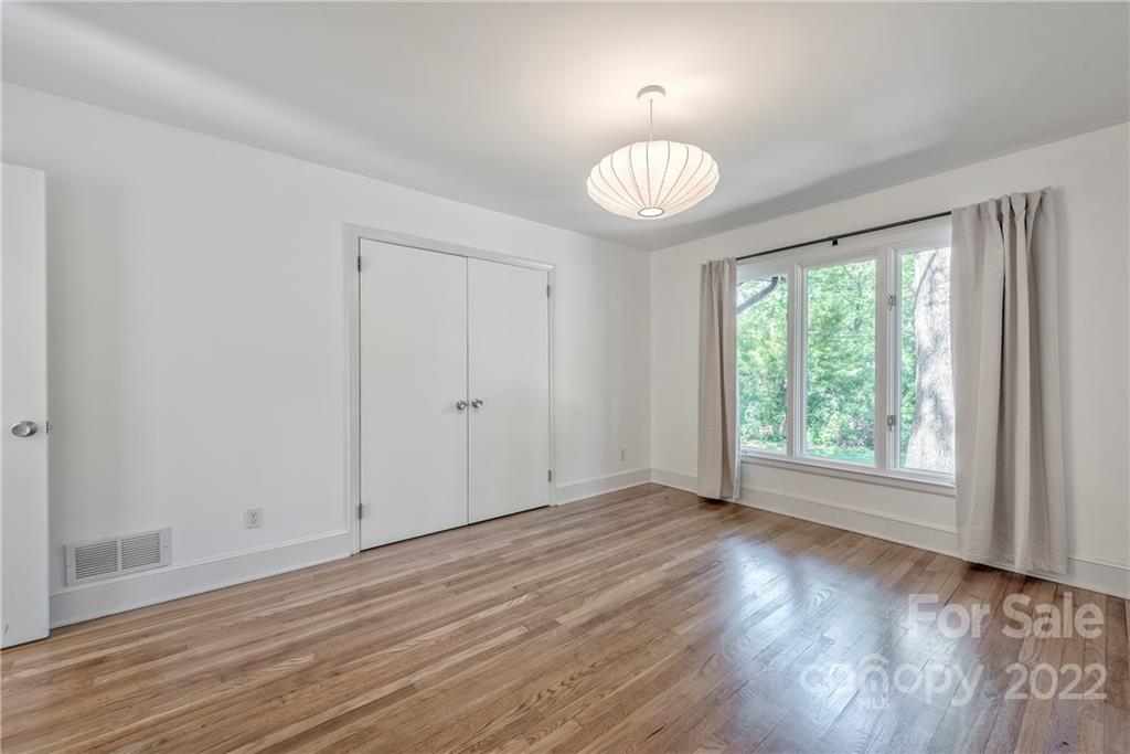 1139 Shady Bluff Drive Charlotte, NC 28211 - Photo 37 of 46 an empty room with wooden floor and windows