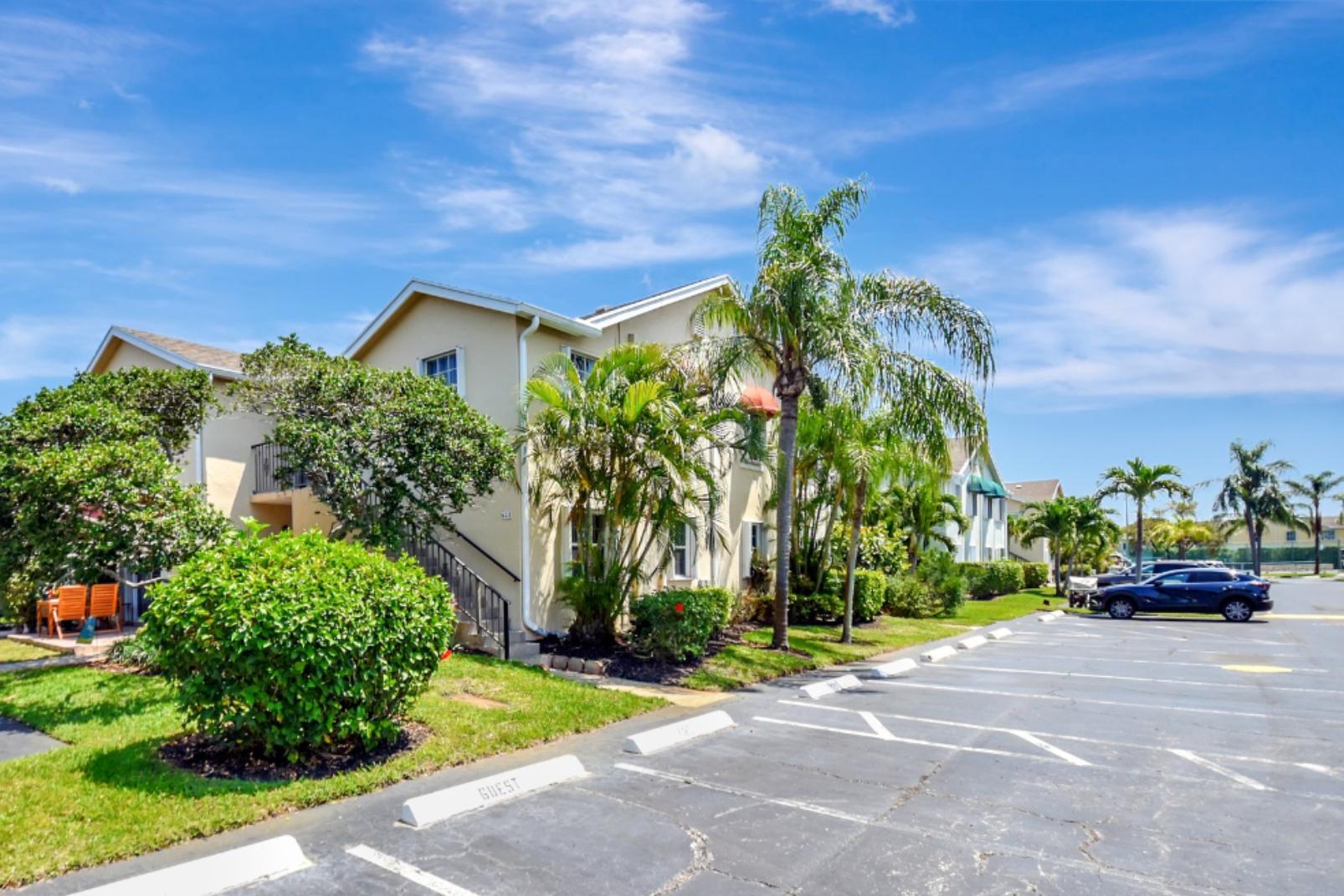 621 Waterside Drive Hypoluxo, FL 33462 - Photo 18 of 27 a car parked in front of a house with a small yard