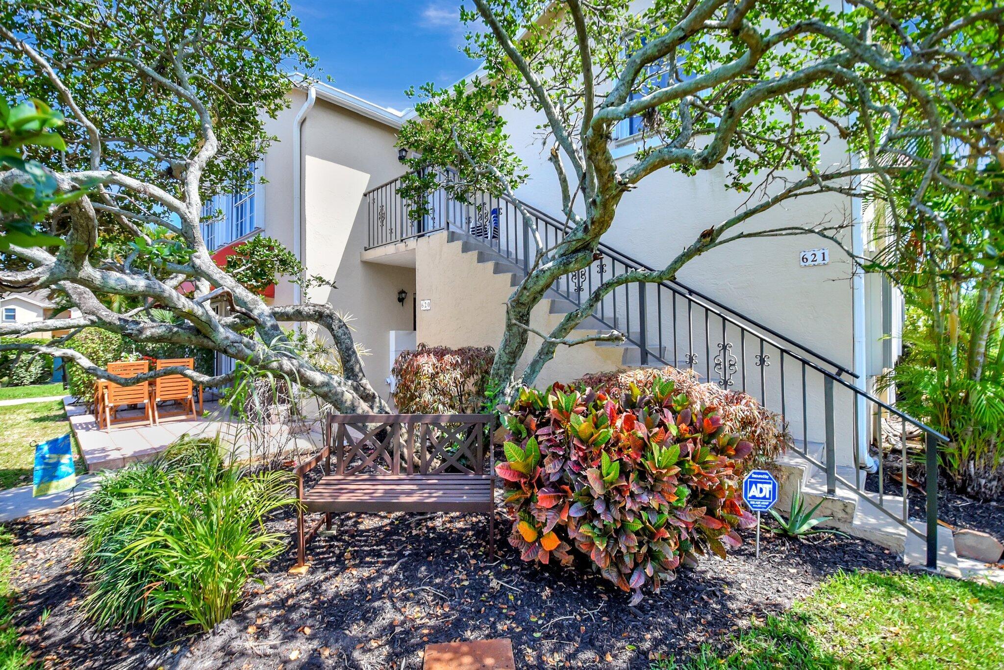 621 Waterside Drive Hypoluxo, FL 33462 - Photo 3 of 27 a view of a porch with a flower garden
