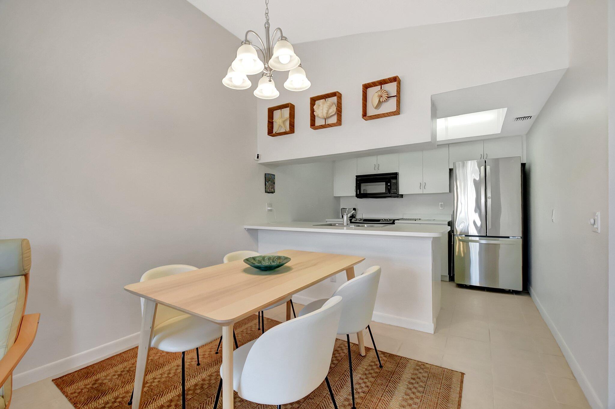 621 Waterside Drive Hypoluxo, FL 33462 - Photo 5 of 27 a view of kitchen and dining area with furniture