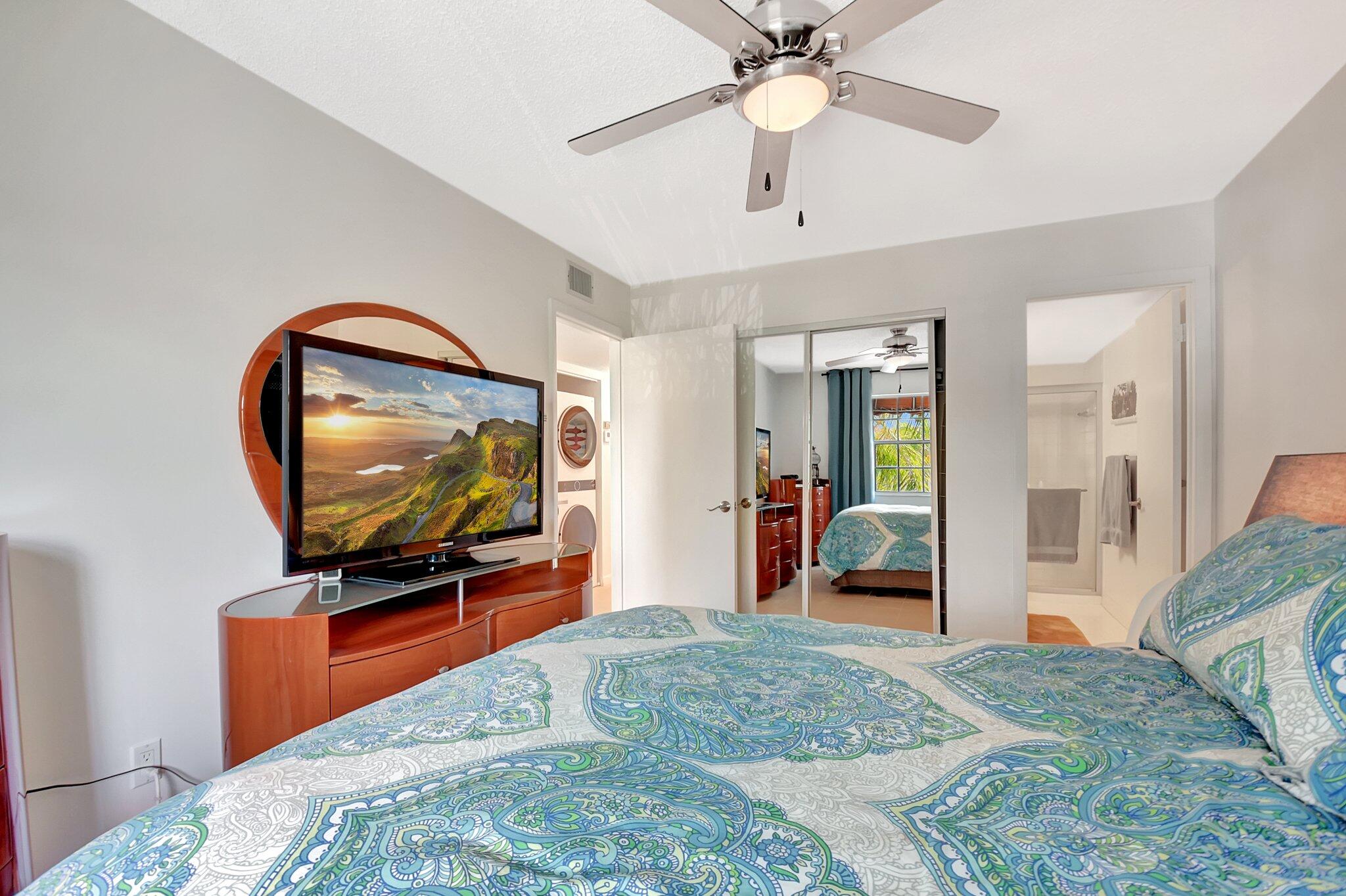 621 Waterside Drive Hypoluxo, FL 33462 - Photo 10 of 27 a bedroom with a bed and a flat screen tv