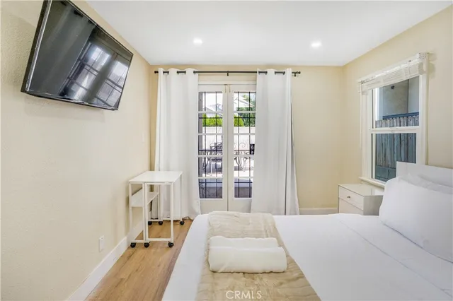 a bed room with a bed window and flat screen tv