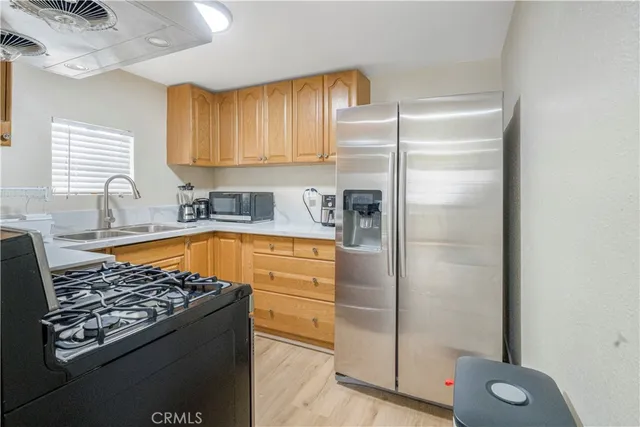 a stove top oven sitting inside of a kitchen