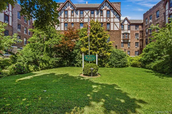 a view of a big yard in front of a brick building