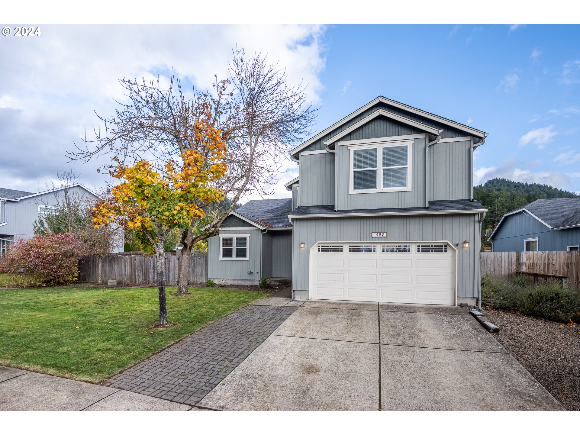 1455 South 58th Street Springfield, OR 97478 - Photo 1 of 39 a front view of a house with a yard and garage