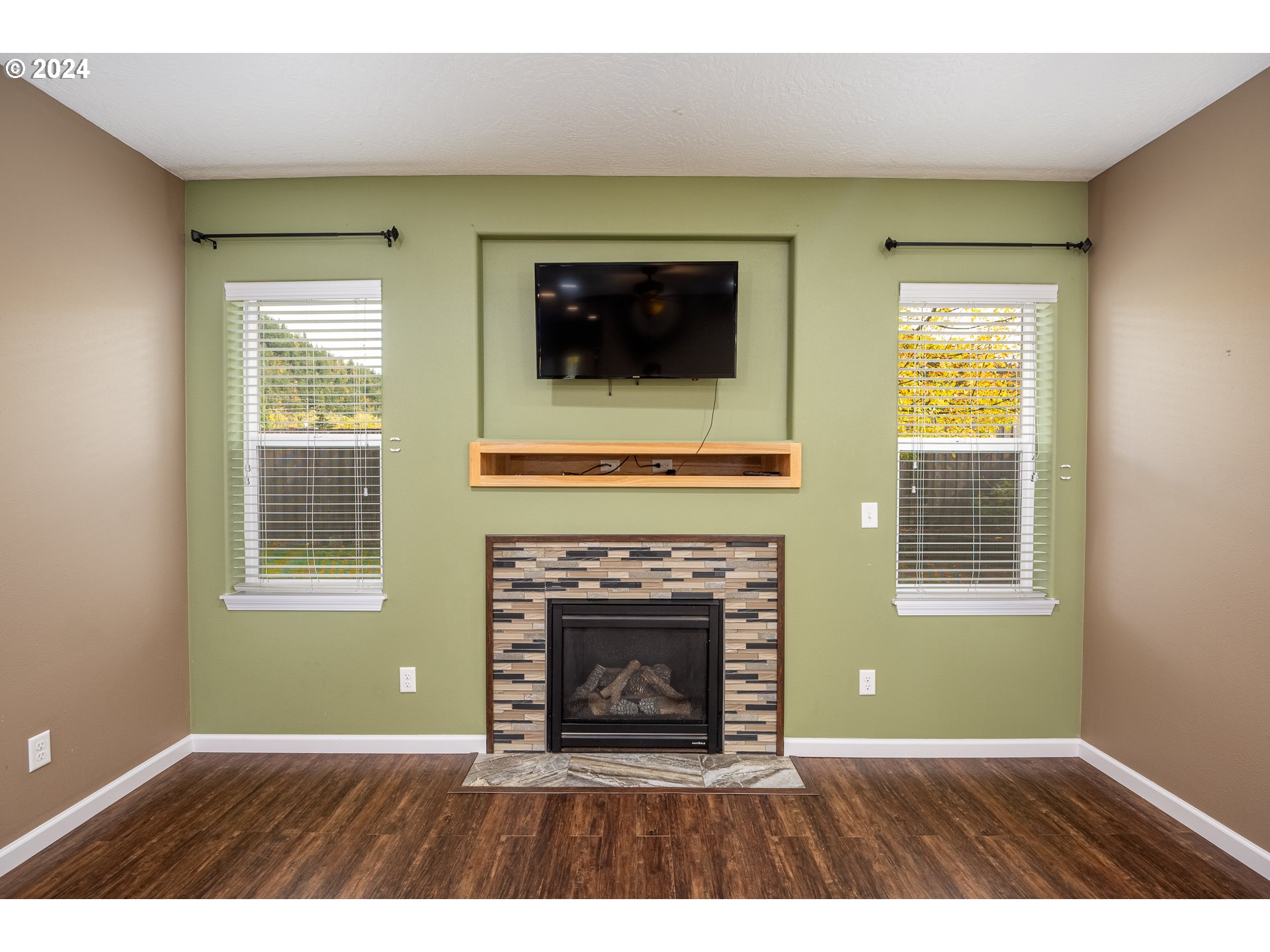 1455 South 58th Street Springfield, OR 97478 - Photo 14 of 39 a living room with a fireplace and a window