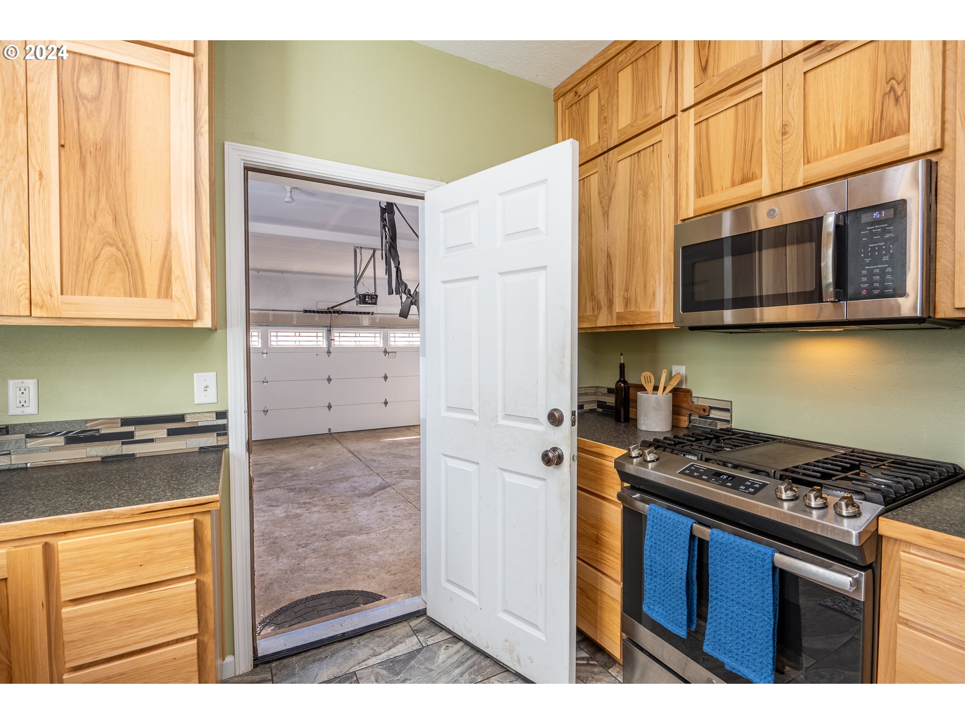 1455 South 58th Street Springfield, OR 97478 - Photo 19 of 39 a kitchen with stainless steel appliances granite countertop a stove and a microwave