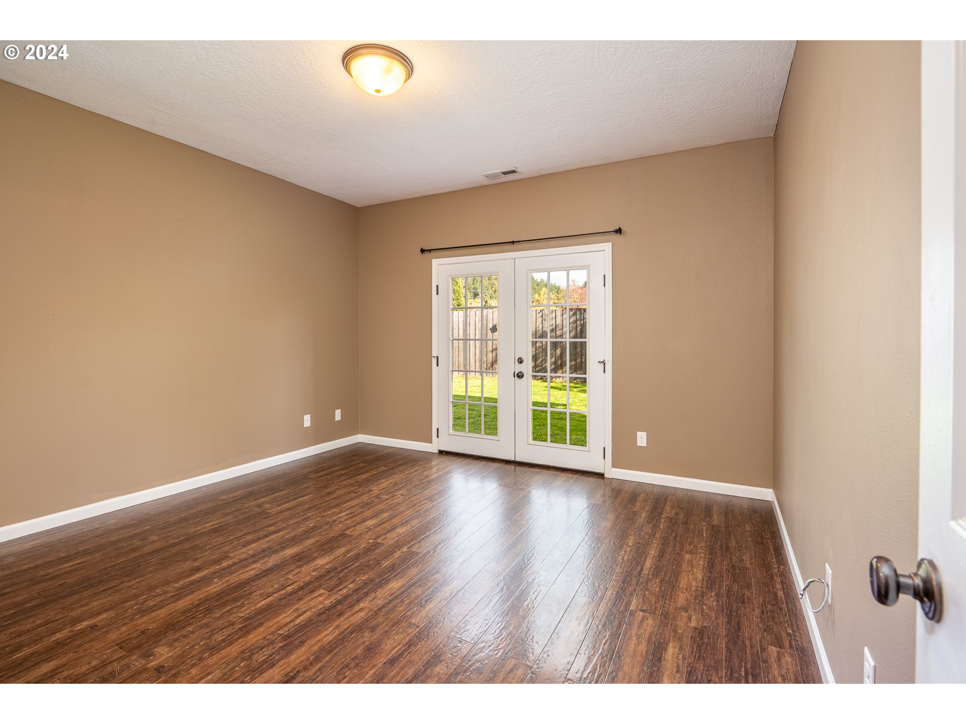 1455 South 58th Street Springfield, OR 97478 - Photo 4 of 39 a view of an empty room with wooden floor and a window