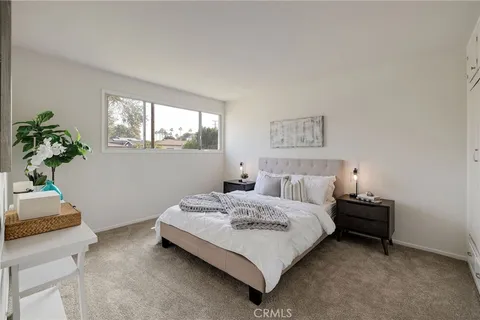 a bedroom with a bed and a potted plant