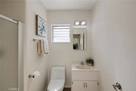 a white toilet sitting next to a bathroom sink
