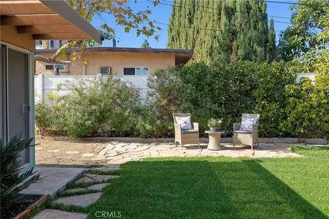 a view of outdoor space with garden and seating area