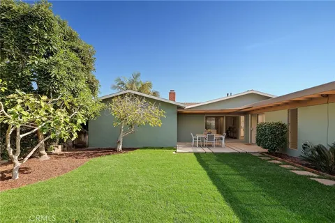 a view of a patio with table and chairs under an umbrella
