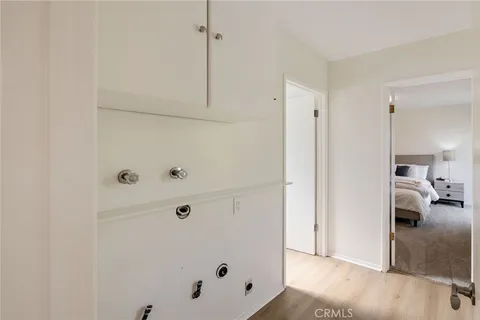 a view of a bedroom with wooden floor