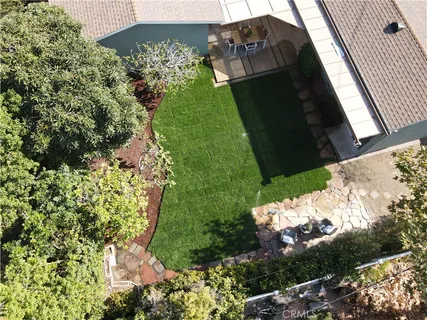 an aerial view of a house with a yard