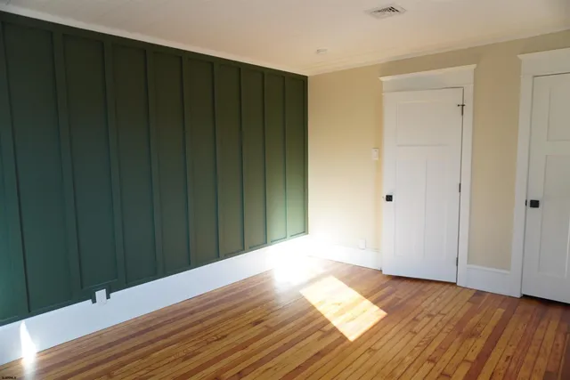 a view of wooden floor and windows in a room